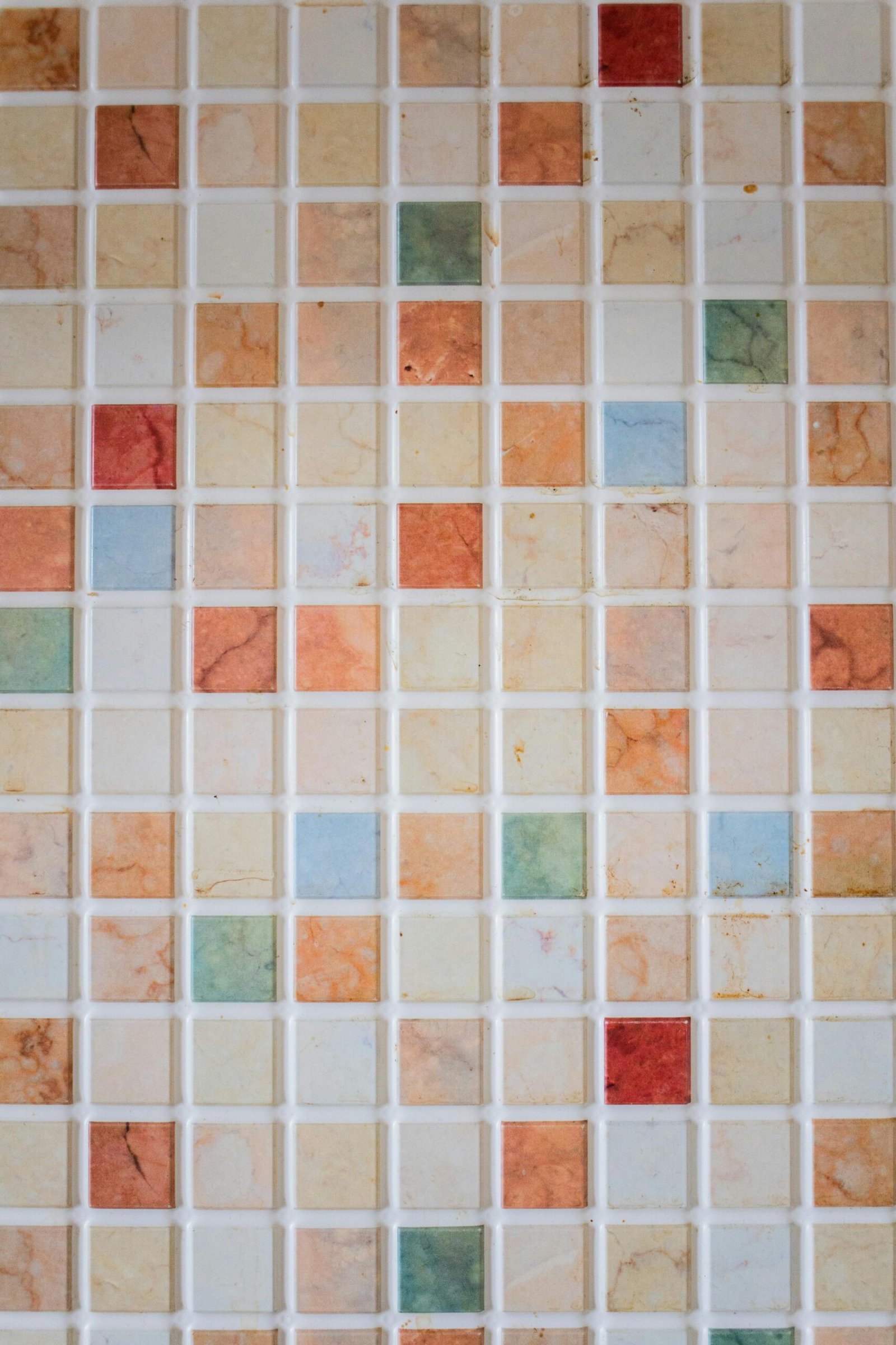 A vibrant mosaic tile wall with multicolored geometric patterns.